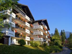 a large apartment building with balconies on a hill at Allgäu Appartementhaus Appartement ALLGÄU 08 in Pfronten