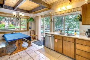 a kitchen with a table in the middle of it at 10 Mi to Lake Tahoe Beaches Home with Pool Table in South Lake Tahoe