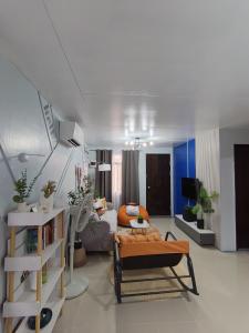 a living room with a couch and a table in it at 2BR FULL Airconditioned Spacious-Cozy &Relaxing in Davao City