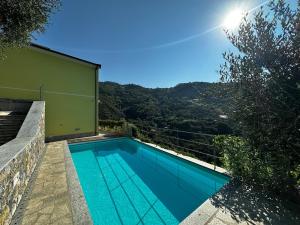 a swimming pool with a view of a mountain at House in Paradise in Moneglia