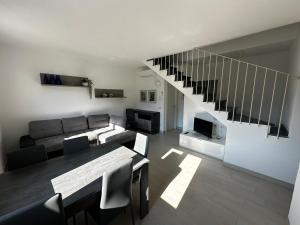 a living room with a couch and a table at House in Paradise in Moneglia
