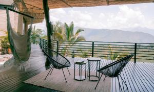 two chairs and a table on a deck with a view at Kasaurora in Tobia +32 photos