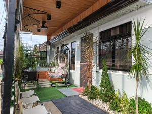 an outdoor patio with a chair and plants at 2BR FULL Airconditioned Spacious-Cozy &Relaxing in Davao City