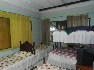 a room with three bunk beds and a television at Casa con Piscina cerca a Neiva 1 in Palermo +11 photos