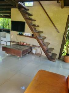 a living room with a couch and a staircase at Vista Bella HostHouse 2 in Brasilia +22 photos