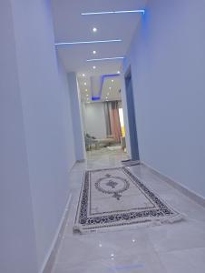 a hallway with a rug on the floor in a house at شقه فندقيه اول سكن in Cairo +2 photos