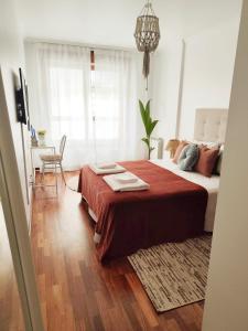 a bedroom with a bed with a red blanket at Merendero de Briz in Marín