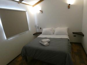 a room with a bed with a chalkboard on the wall at Cabañas Los Tamarindos in Algarrobo +22 photos