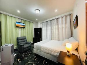 a hotel room with a bed and a chair at Casa Borde de lago2 in Panajachel