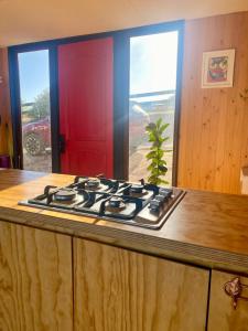 a stove top oven in a kitchen with a window at Casa de campo Matanzas in Navidad +23 photos