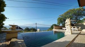 a swimming pool with a fountain in a house at Bayu Hotel Lipah Beach in Karangasem