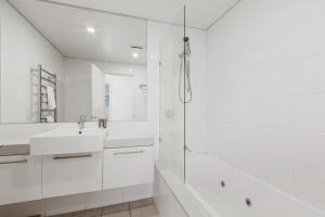 a white bathroom with a sink and a shower at Moritz 1 in Mount Hotham +5 photos