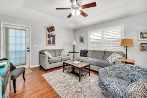 a living room with a couch and a table at The Squeezebox in Saint Simons Island