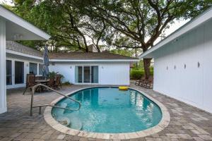 a swimming pool in front of a house at 4310 Ninth Street in Saint Simons Island