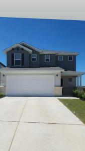 a large house with a white garage at Private Cozy Room and Bathroom in Home near Seaworld Riverwalk and AFB in San Antonio