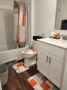 a bathroom with a toilet and a sink at Private Cozy Room and Bathroom in Home near Seaworld Riverwalk and AFB in San Antonio