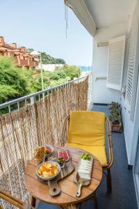 a table with a bowl of food on a balcony at ONA House Begur in Sa-Riera
