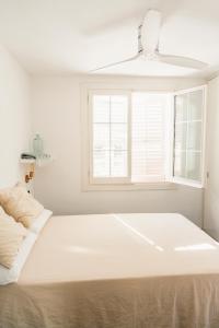 a large white bed in a room with a window at ONA House Begur in Sa-Riera +19 photos