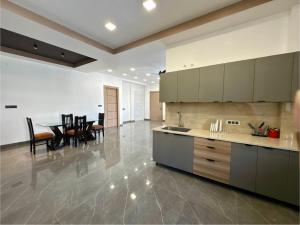 a large kitchen with a table and a dining room at Skywood Villa Apartment in Lucknow