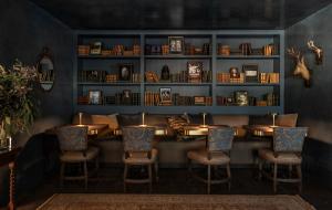 a dining room with a table and chairs and shelves at Hotel Granduca Houston in Houston