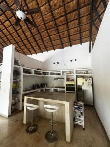 a kitchen with a counter and stools in it at Casa El Cielo in Piedecuesta +33 photos