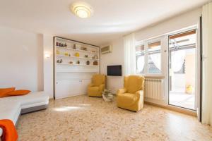 a bedroom with two chairs and a bed and a tv at Tempio del Sole in Rome