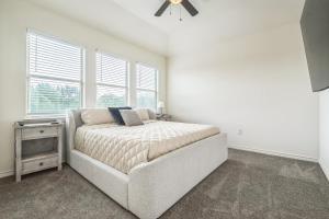 a bedroom with a bed and a ceiling fan at Hi-Tech Haven by Hospital & Lake in Granbury