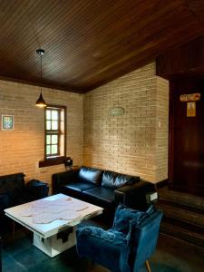 a living room with a couch and a table at Canto das Toninhas Guest House in Ubatuba +30 photos