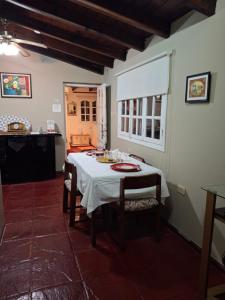 a dining room with a white table with chairs at Un espacio en la naturaleza in Salta