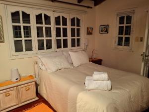 a bedroom with a bed with towels on it at Un espacio en la naturaleza in Salta