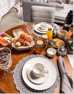 a table with plates of food on top of it at Le Mont Chalés in Bento Gonçalves