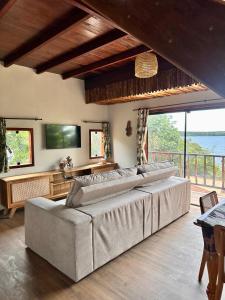 a large bed in a room with a large window at Vila da Mata in Alter do Chao