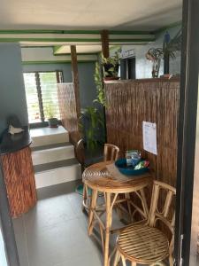 a table and chairs in a room with a table at Color Hostel in Dapa