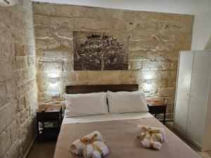 a bedroom with a bed with two bows on it at Casa Petra Bari in Bari