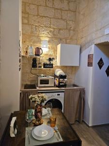 a small kitchen with a table and a microwave at Casa Petra Bari in Bari
