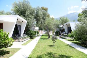 a view of the courtyard of a house with trees at Luna Mare Boutique Seaside in Borsh