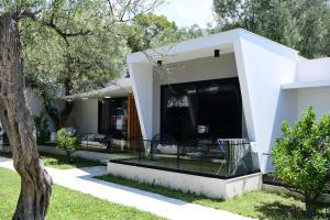 a white house with a glass facade at Luna Mare Boutique Seaside in Borsh