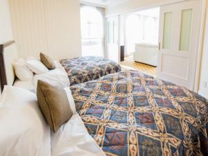 Postel nebo postele na pokoji v ubytování Spa Resort LiVEMAX