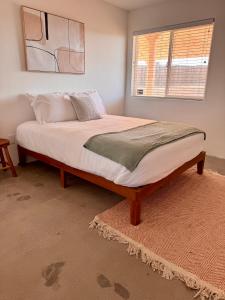 a large bed in a room with a window at Casita Bonita - Hot Tub, Views, Sunsets in Landers +10 photos