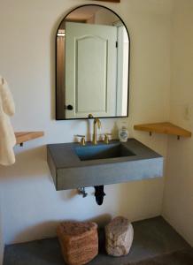 a bathroom with a sink and a mirror at Casita Bonita - Hot Tub, Views, Sunsets in Landers