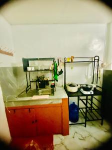 a kitchen with a counter and a table in a room at Budget-StudioRoom-Panabo-Homestay in Panabo