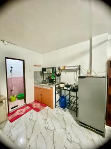 a room with a kitchen with a table and a counter at Budget-StudioRoom-Panabo-Homestay in Panabo