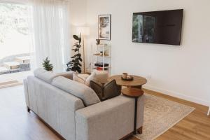 a living room with a couch and a table at Private & Stylish Hinterland Cottage in Gold Coast