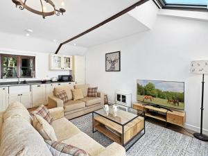 a living room with a couch and a table at Byre Cottage Dulverton in Dulverton