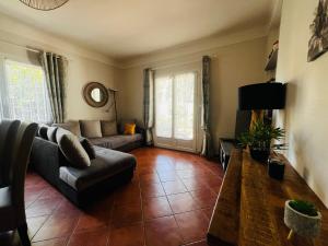 a living room with a couch and a table at Maison à Argelès Plage, 50m de la Mer, WIFI, Clim, Terrasse, Parking Privé - FR-1-309-322 in Argelès-sur-Mer