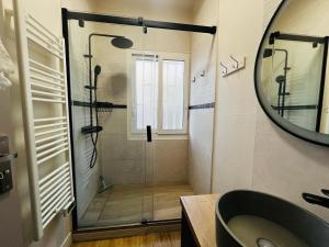 a bathroom with a shower with a glass door at Maison à Argelès Plage, 50m de la Mer, WIFI, Clim, Terrasse, Parking Privé - FR-1-309-322 in Argelès-sur-Mer +8 photos