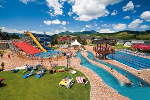 a water park with a pool and a water slide at Apartmán ELIZABETH in Bešeňová