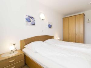 Katil atau katil-katil dalam bilik di Kurpark-Residenz Apartment Kugelbake