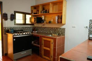 a kitchen with a stove and a counter top at Casa Lirio in San Juan La Laguna +15 photos