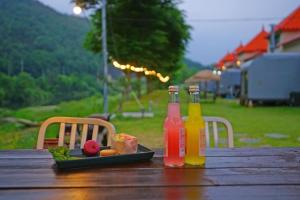 two bottles of juice and a plate of food on a table at Cheongju Crepas Pension in Cheongju